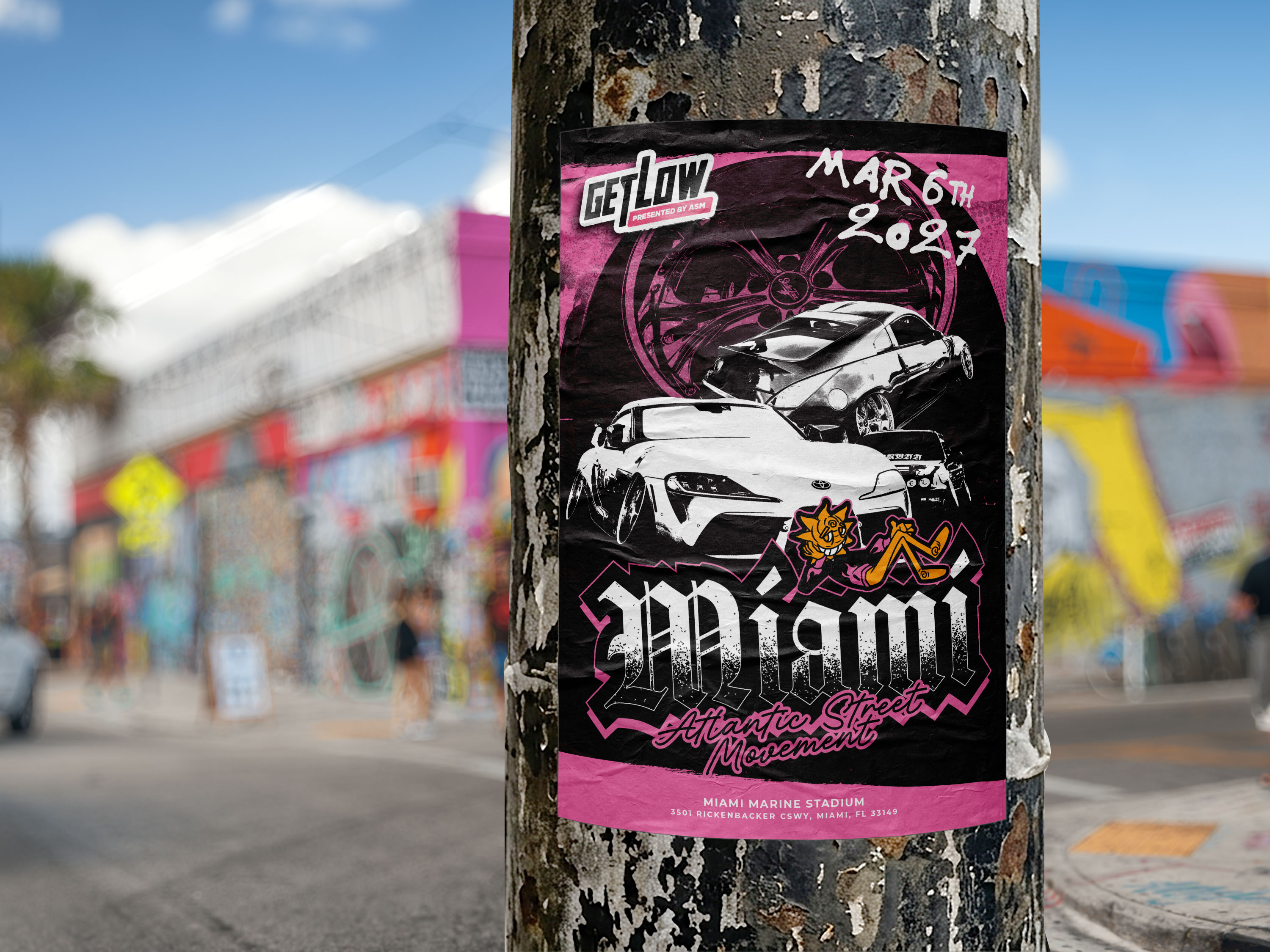 Get Low Miami 2027 flyer posted on a tree in a colorful street setting